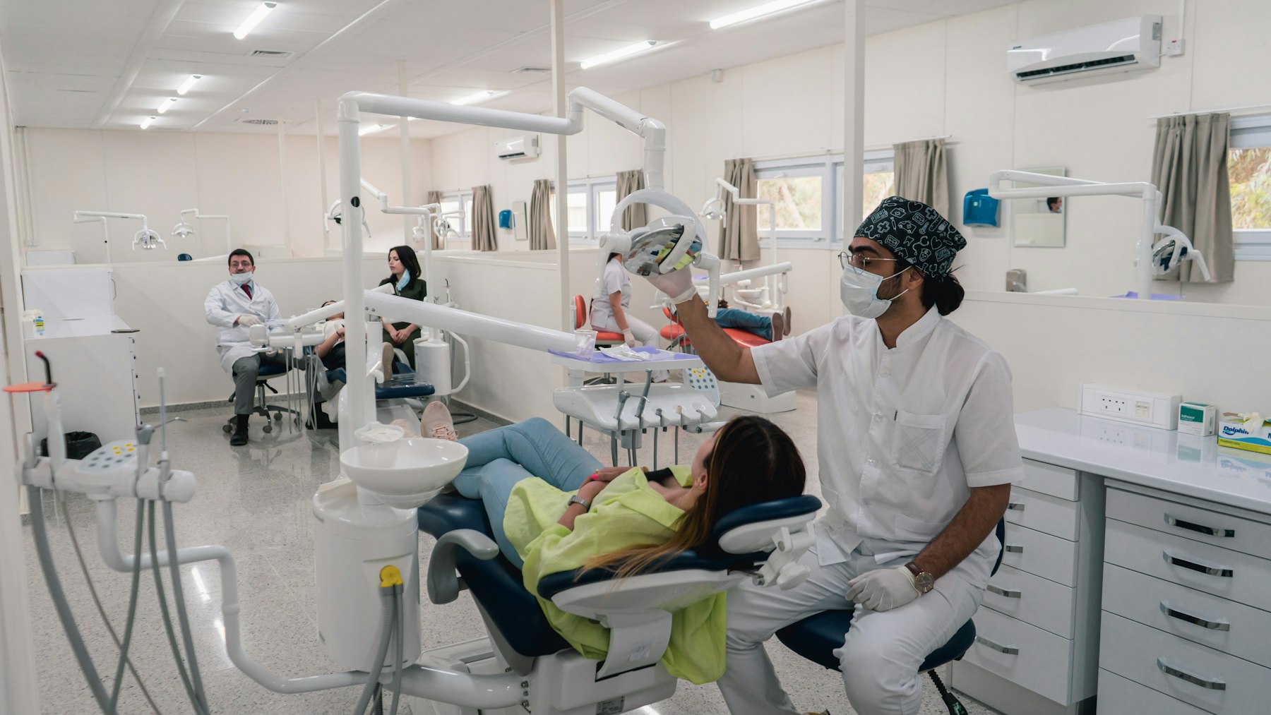 A patient receiving a consultation in a dental treatment room